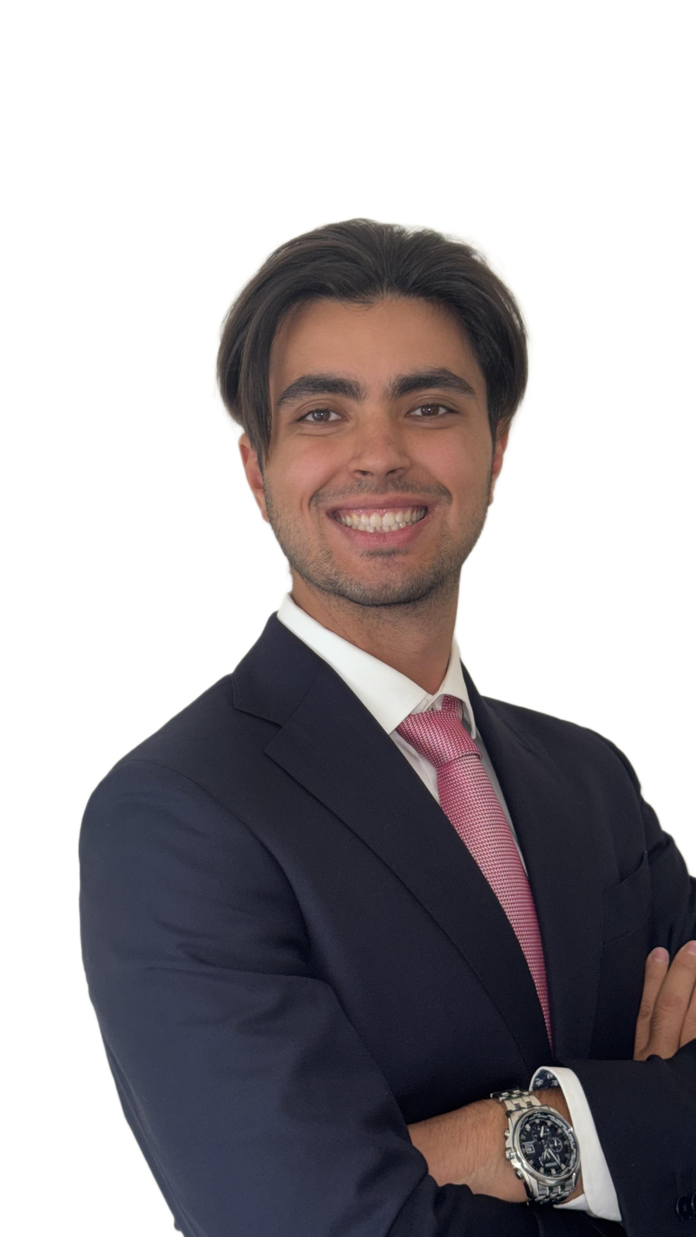 Julio Macias Gonzalez wearing a navy suit and pink tie